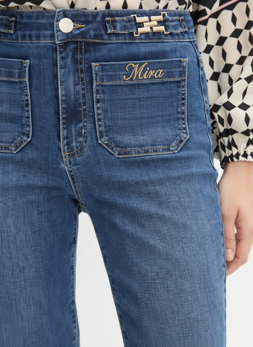 Jeans with MIRA in cursive on front pocket